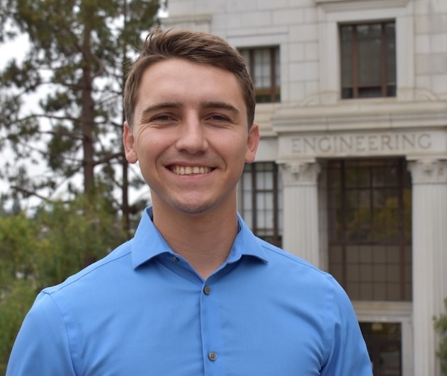 Headshot of Brett Bussell in front of a building that reads 'Engineering'